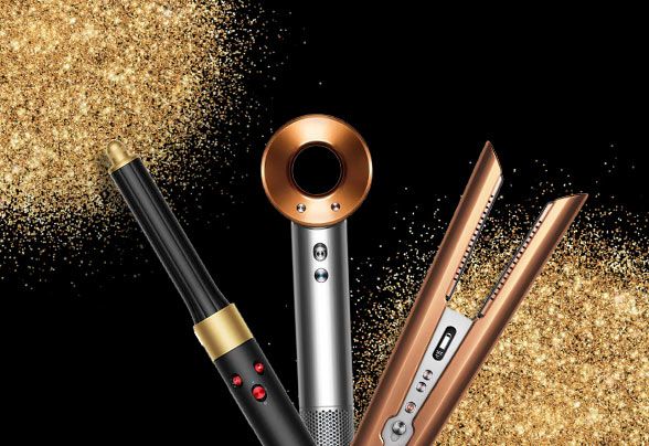 Dyson products surrounded by gold glitter on a black background